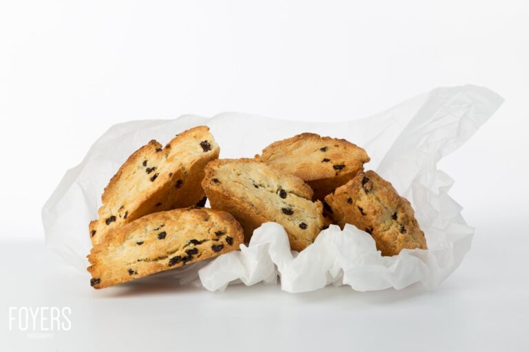 Golden scones with raisins on white paper