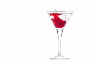Martini glass with red liquid swirl