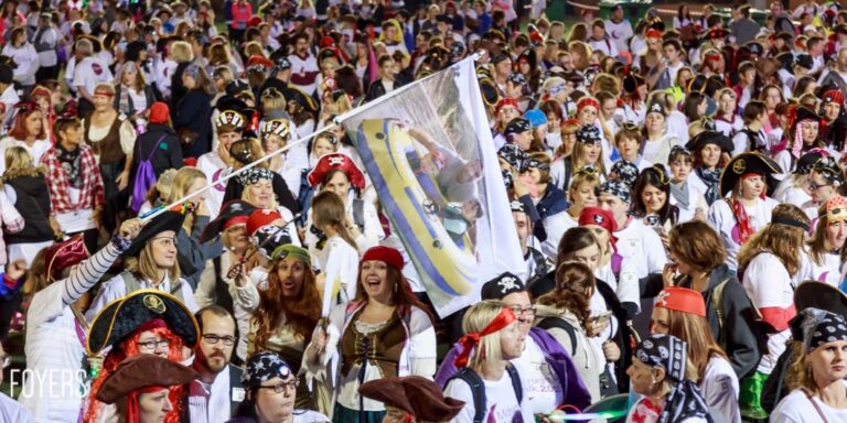 Crowd in pirate costumes at a festive event.