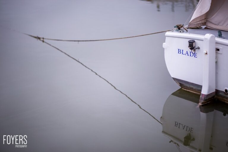 Boat named Blade anchored on calm water