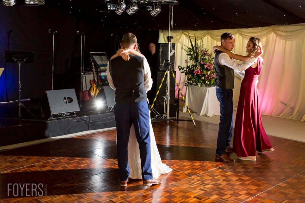 Ally and Alex dancing gracefully to their chosen song, Only Love by Ben Howard with best mad and bridesmaid