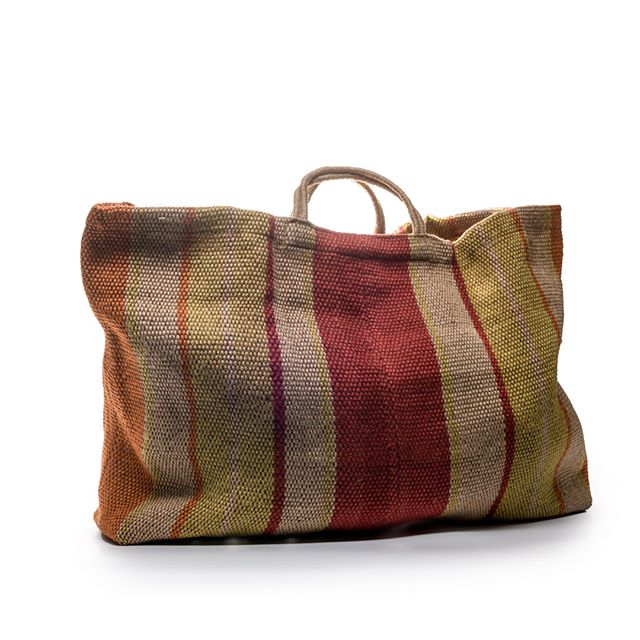 A woven tote bag with vertical stripes in rust, cream, burgundy and olive colours, featuring rope handles.