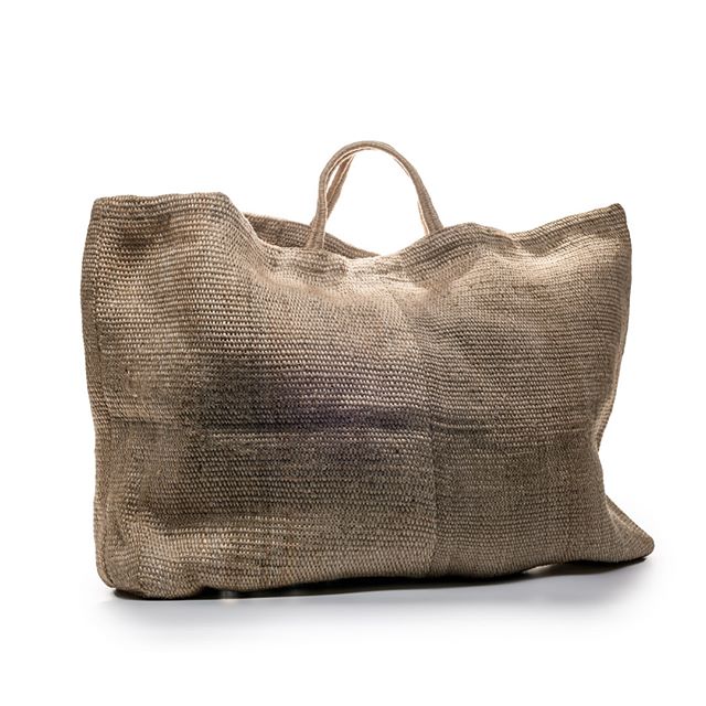 A woven tote bag in natural beige with darker horizontal stripes, featuring two handles, displayed against a white background.