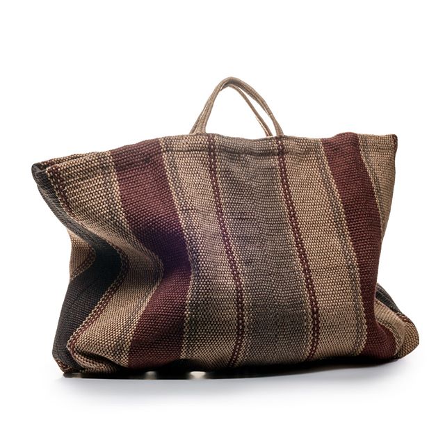 A striped woven tote bag in shades of brown and cream with rope handles, displayed against a white background.