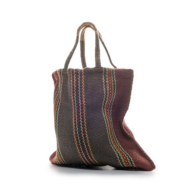A woven tote bag in charcoal grey with coloured striped detailing and dual handles, displayed against a white background.