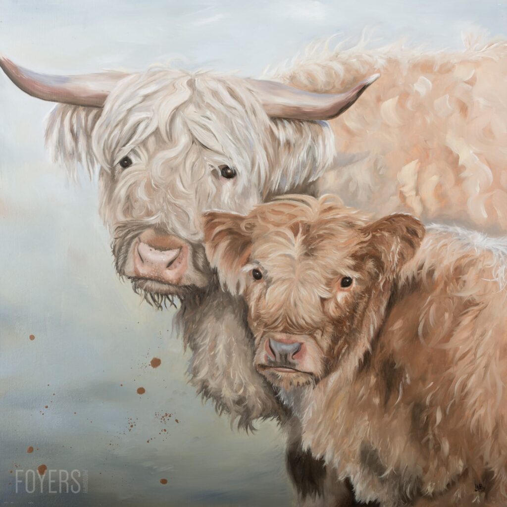 A cream and brown Highland cattle cow with long horns stands beside a smaller brown calf against a misty grey background.