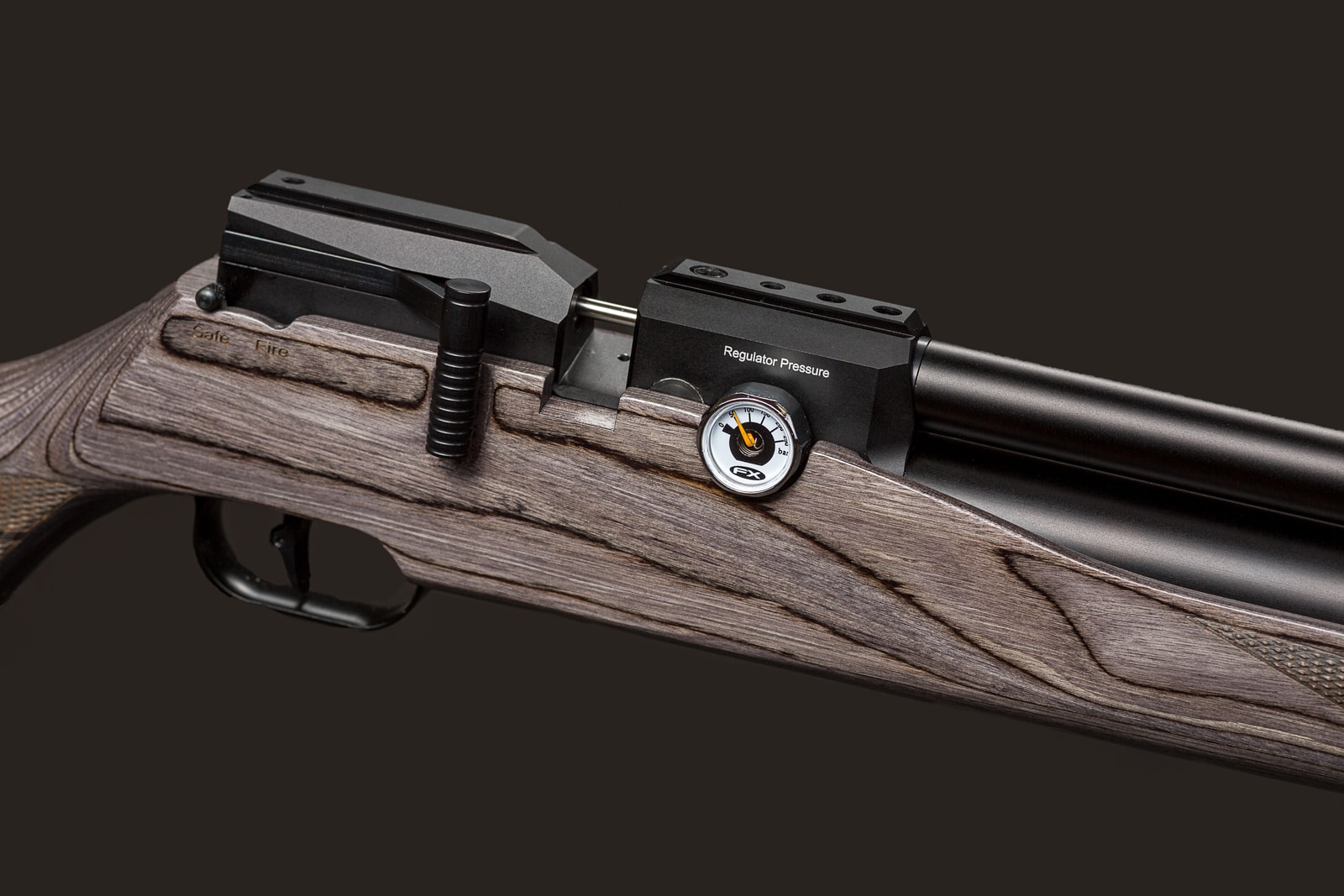 An air rifle with wooden furniture sits against a neutral grey background. A pressure gauge labeled Regulator Pressure is mounted on the barrel.