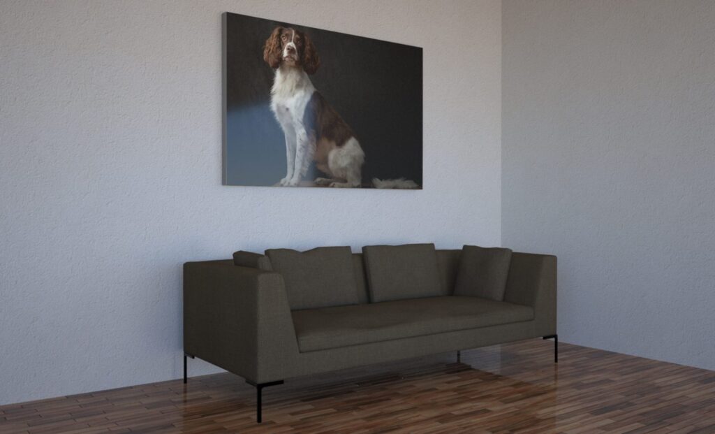 Large framed portrait of a spaniel displayed on a wall above a grey sofa