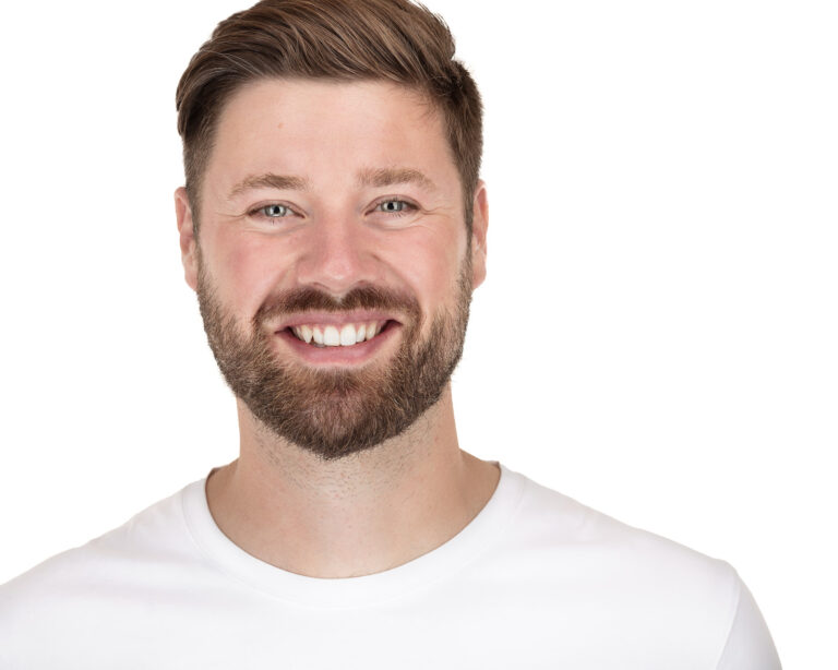 Smiling man with beard and white shirt