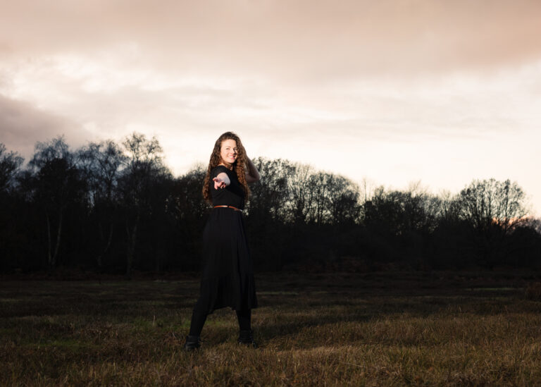 Isabelle posing for a portrait while modelling outdoors