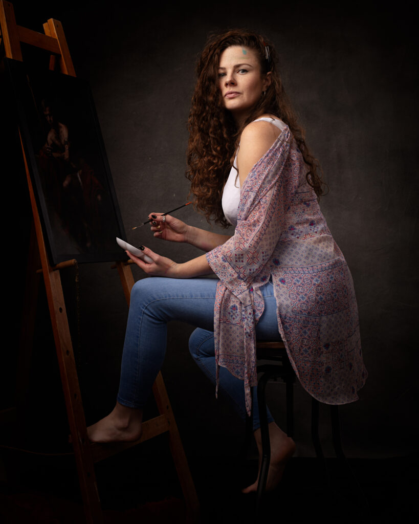 Isabelle's radiant smile and artistic flair shine through in this portrait taken in her studio. As a painter and creative individual, she knows the value of using art as a way to improve mental health and express herself. The photograph perfectly captures her lively personality and passion for her craft.