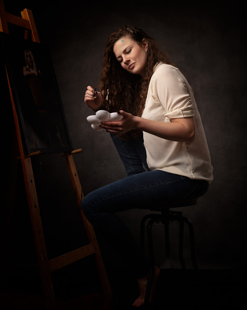 Isabelle radiates creativity and beauty in this stunning portrait taken in her studio. As a painter, she understands the therapeutic benefits of artistic expression and uses it to improve her mental health. The photograph captures her artistic talent and unique spirit, making it a true work of art.
