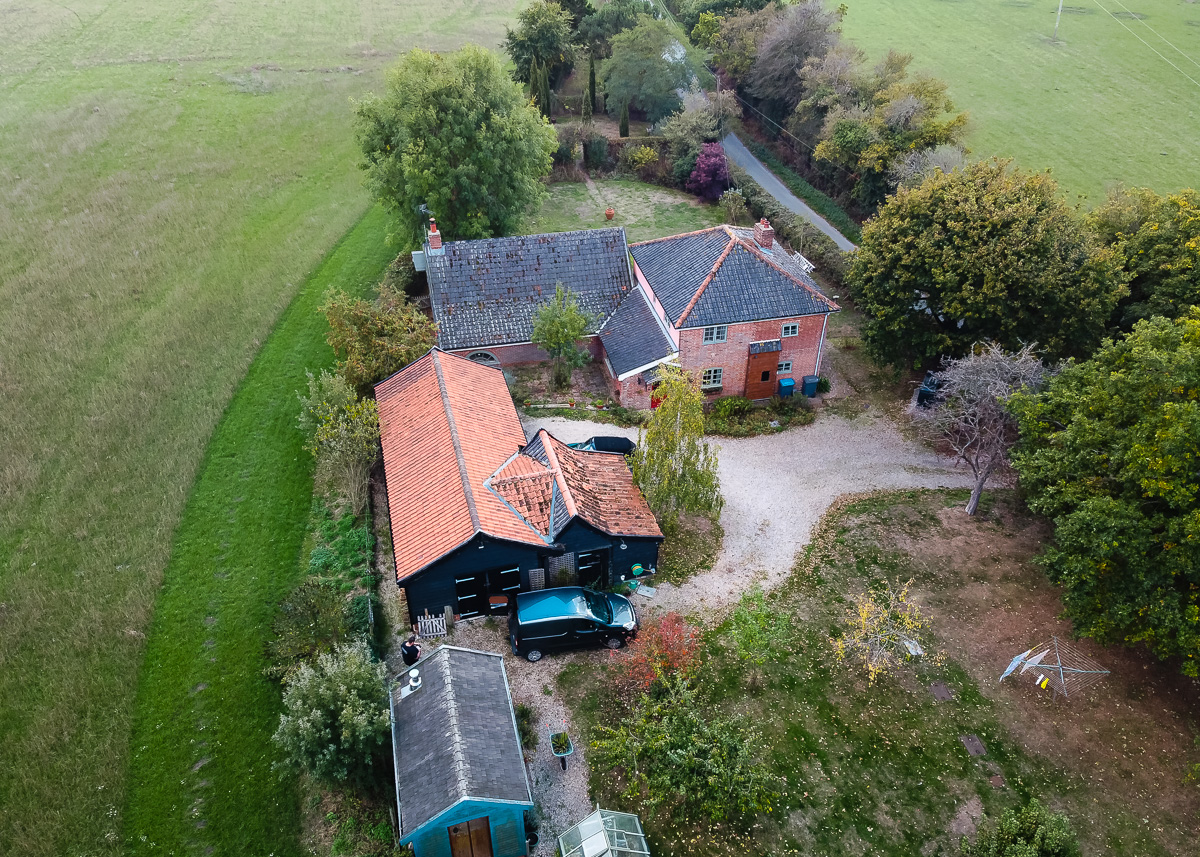 Aerial view of Moss Cottage in Yoxford surrounded by fields and trees