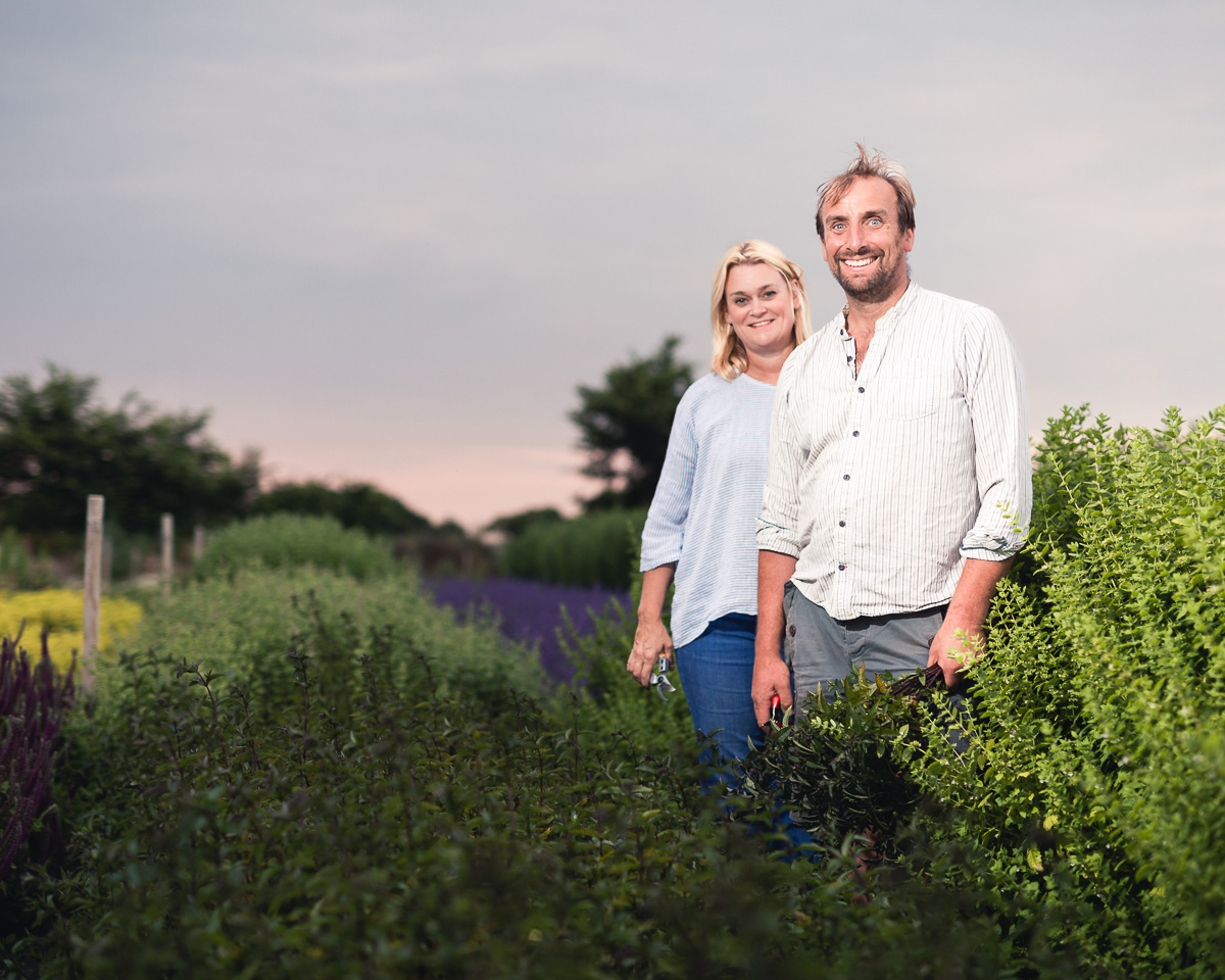 Couple standing among lavender and flowers at dusk, photographed for The Southwold Flower Company