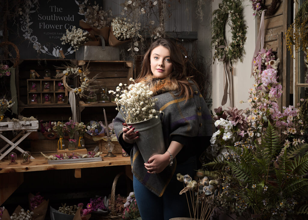 A stunning bouquet of fresh spring flowers captured by Foyers Photography at the Southwold Flower Company. The bouquet features a mix of delicate white and pink blossoms, including tulips, ranunculus, and other seasonal flowers, creating a beautiful and romantic display. The flowers are arranged in a simple glass vase, allowing the natural beauty of the blooms to take centre stage.