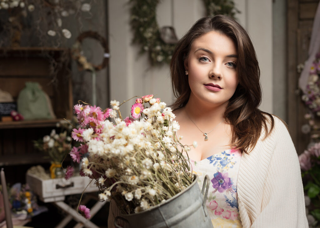 A beautiful arrangement of fresh spring flowers captured by Foyers Photography at the Southwold Flower Company. The bouquet features a mix of vibrant purple and pink tulips, delicate white blooms, and green foliage, creating a stunning and balanced display. The flowers are arranged in a stylish ceramic vase, perfect for adding a touch of colour and charm to any room.