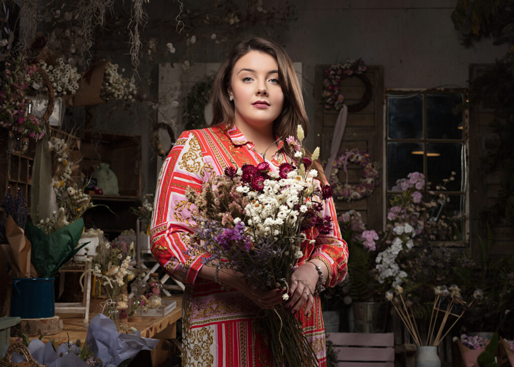 Beautiful bouquet of colorful spring flowers arranged in a rustic wooden box, captured by Foyers Photography at the Southwold Flower Company. The vibrant blooms include roses, tulips, ranunculus, and daffodils, creating a delightful mix of textures and hues.