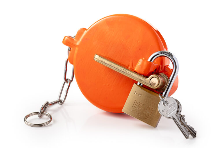 Product photograph of an orange valve lockout with a padlock and keys, photographed for STA Technical