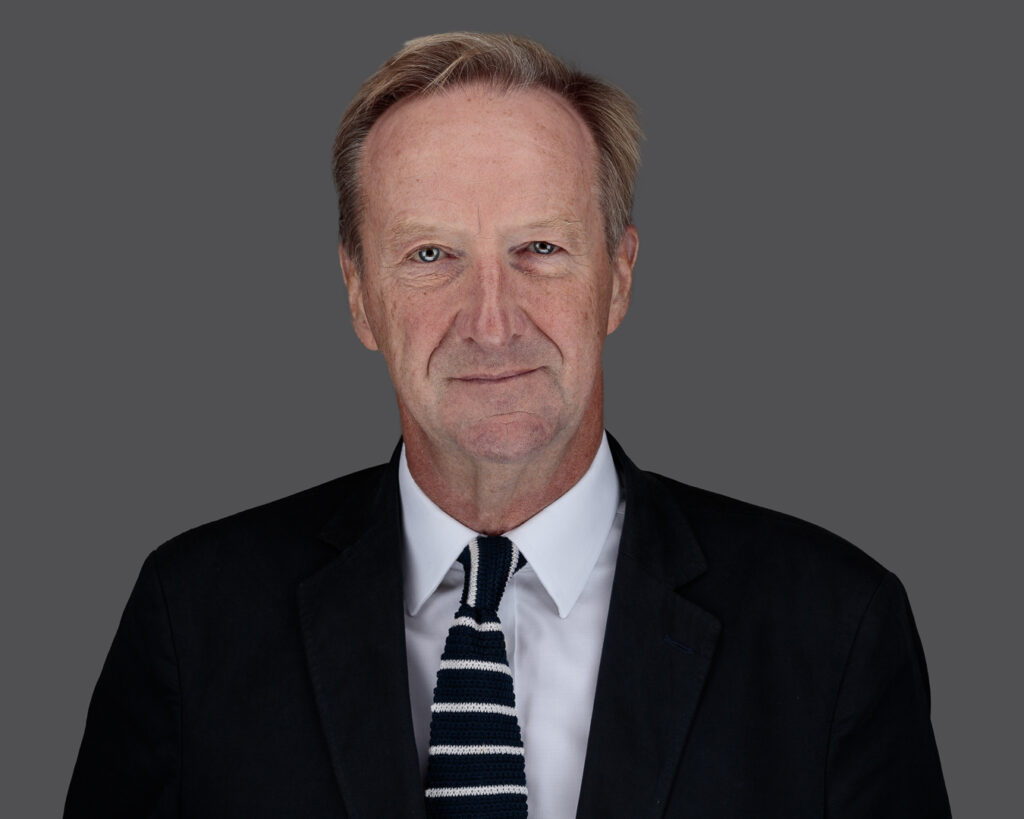 Studio headshot of a man in smart-casual clothing against a light grey background, Foyers Photography Suffolk