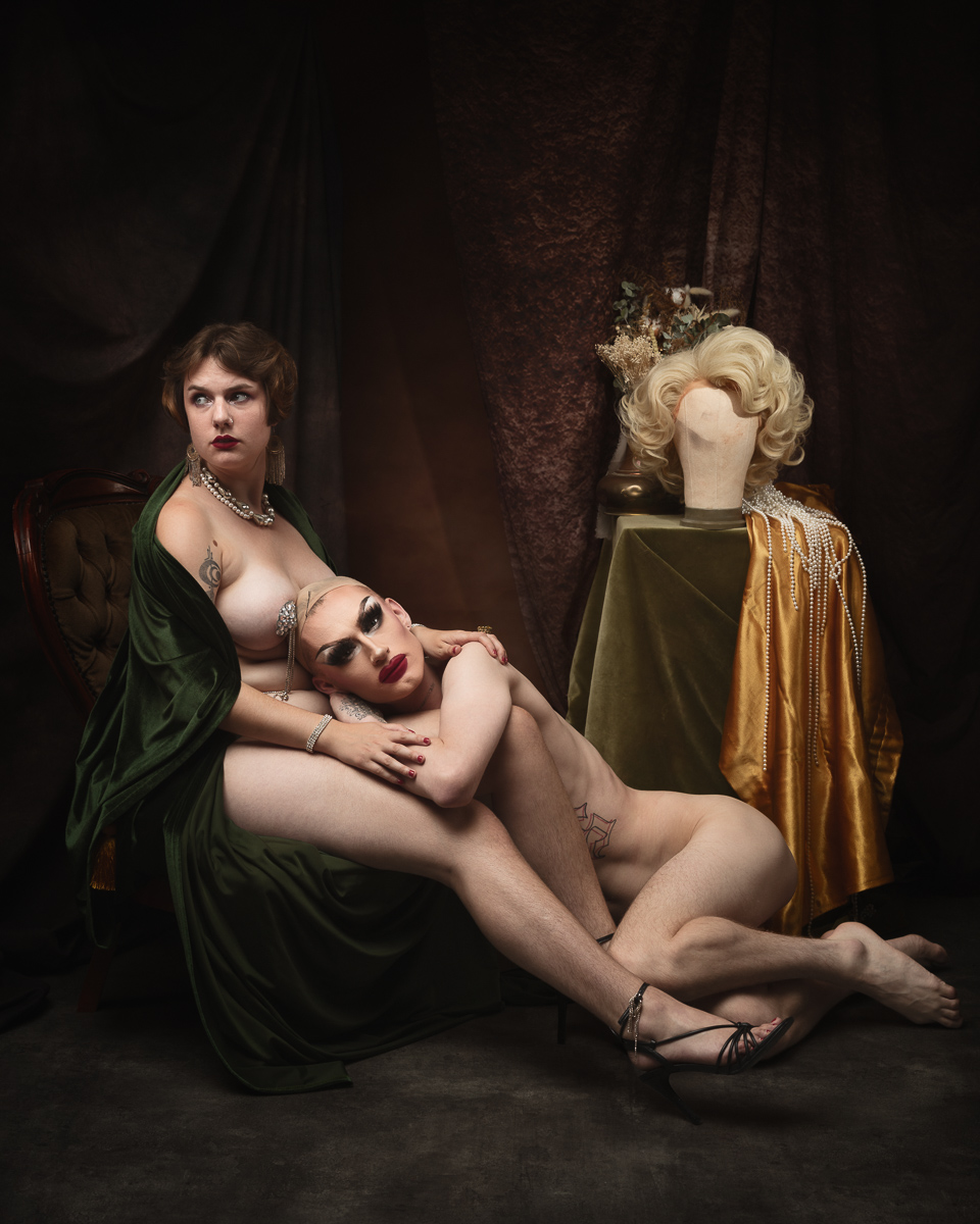Artistic portrait with mannequins and clothed figures.
