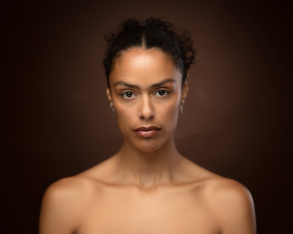 Portrait of woman with dark hair and neutral expression