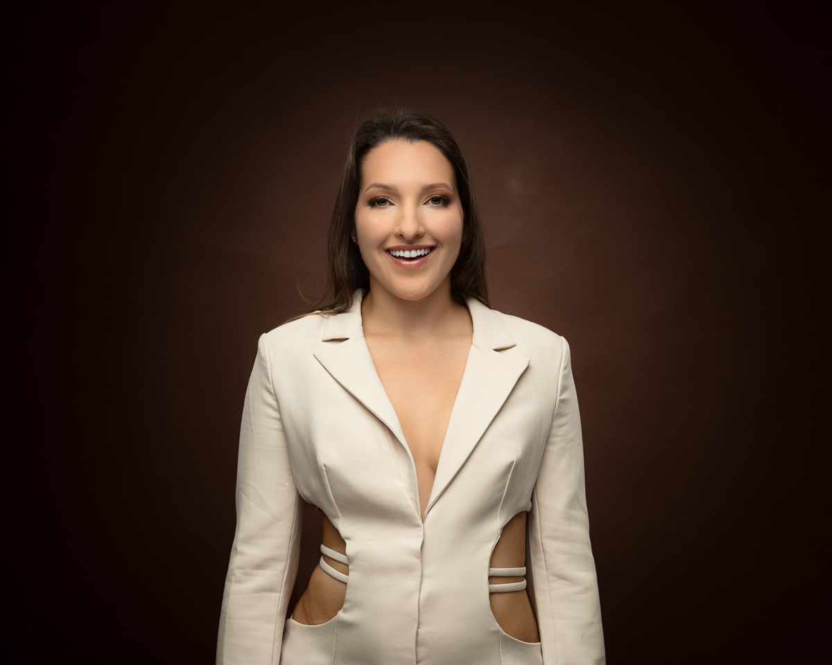 Professional headshot of smiling woman in cream blazer