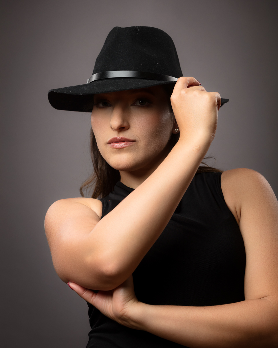 Woman wearing black cowboy hat and sleeveless top portrait