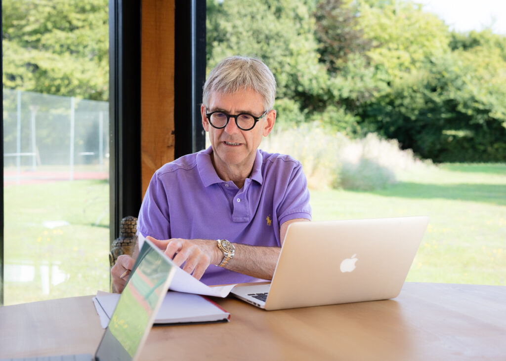 Man working on laptop in garden room