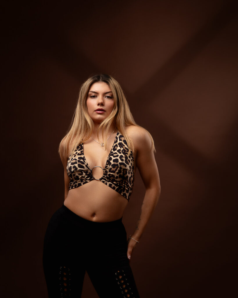 Woman in leopard print top and black trousers.