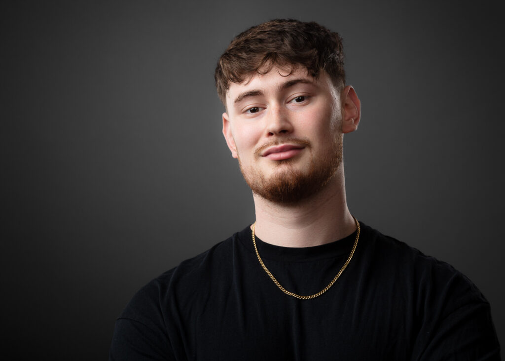 Man in black shirt with chain necklace