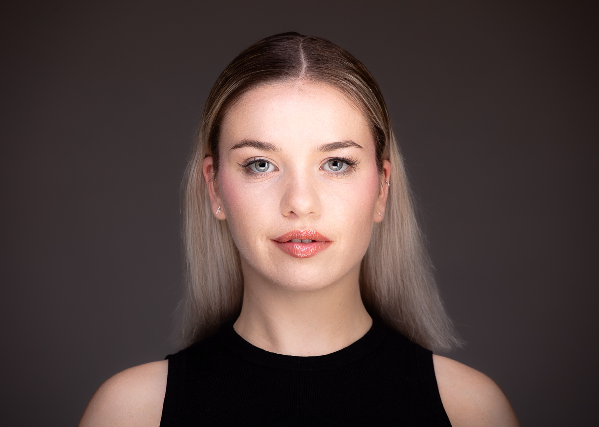 Woman with blonde hair staring straight.