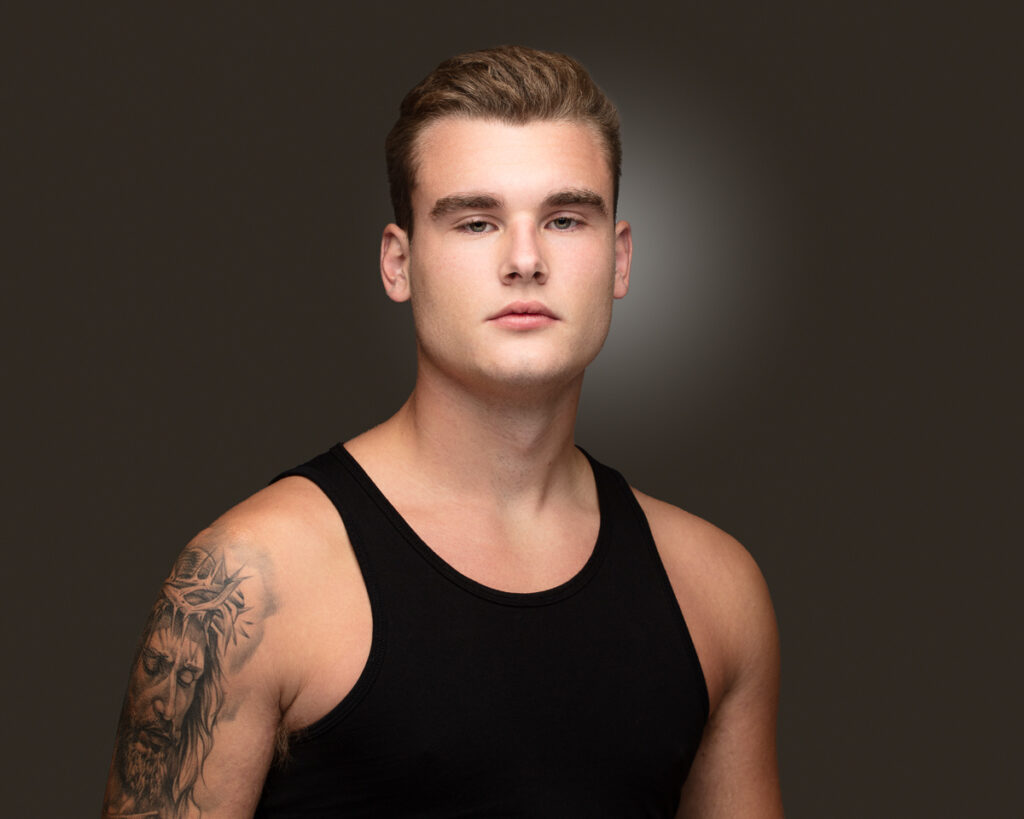 Man with tattoo in black tank top
