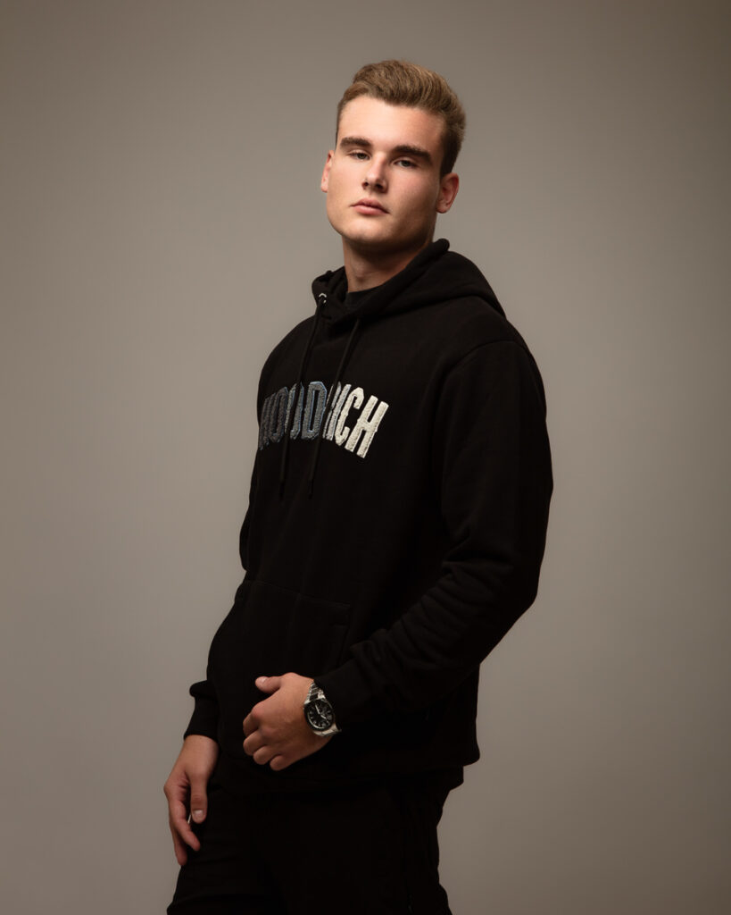 Man wearing black hoodie posing.