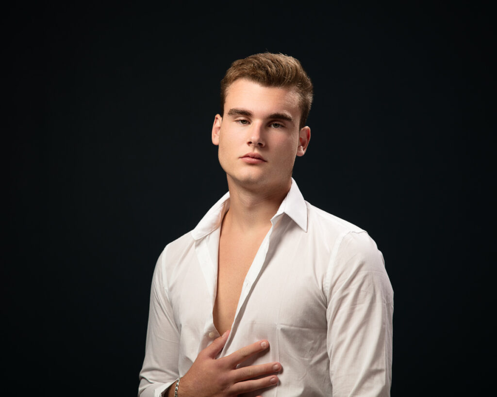 Man in white shirt with open collar