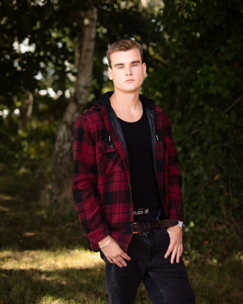 Man in red plaid jacket in forest