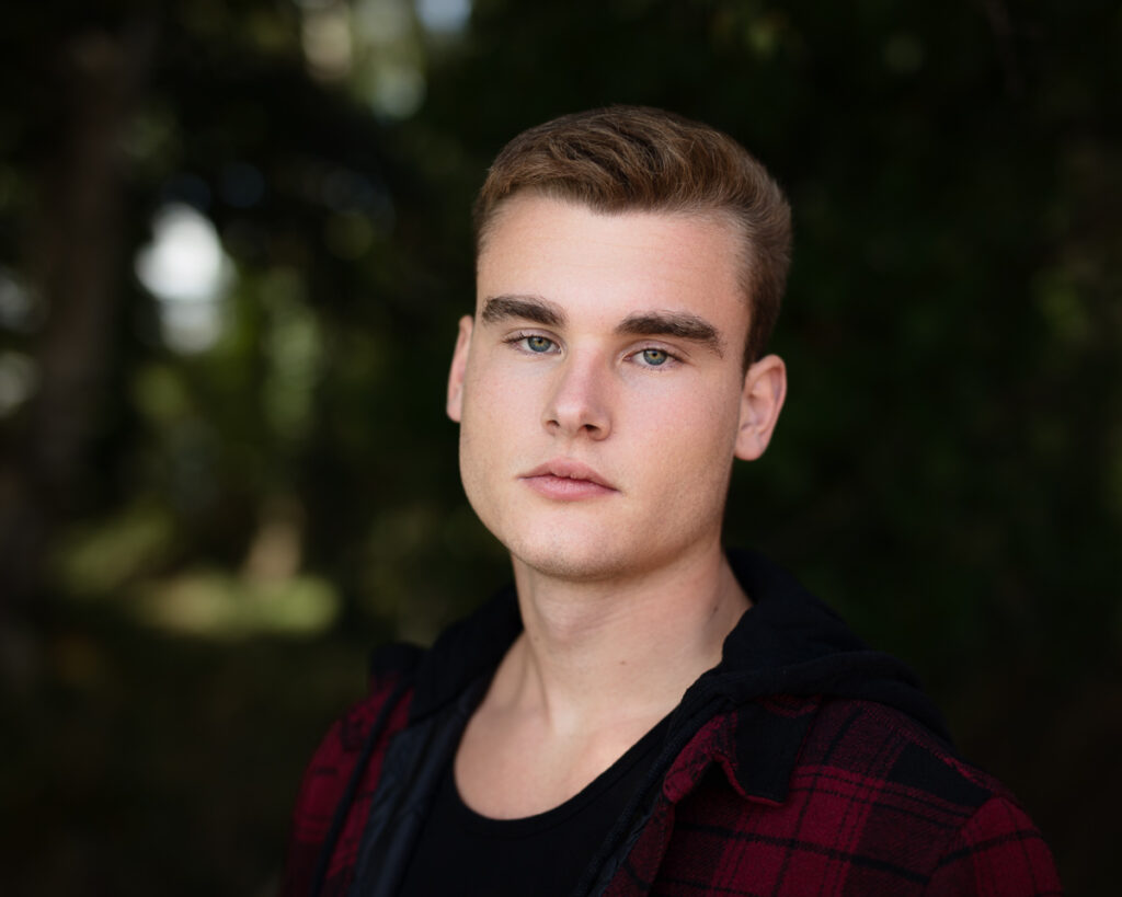 Young man in red flannel shirt outdoors