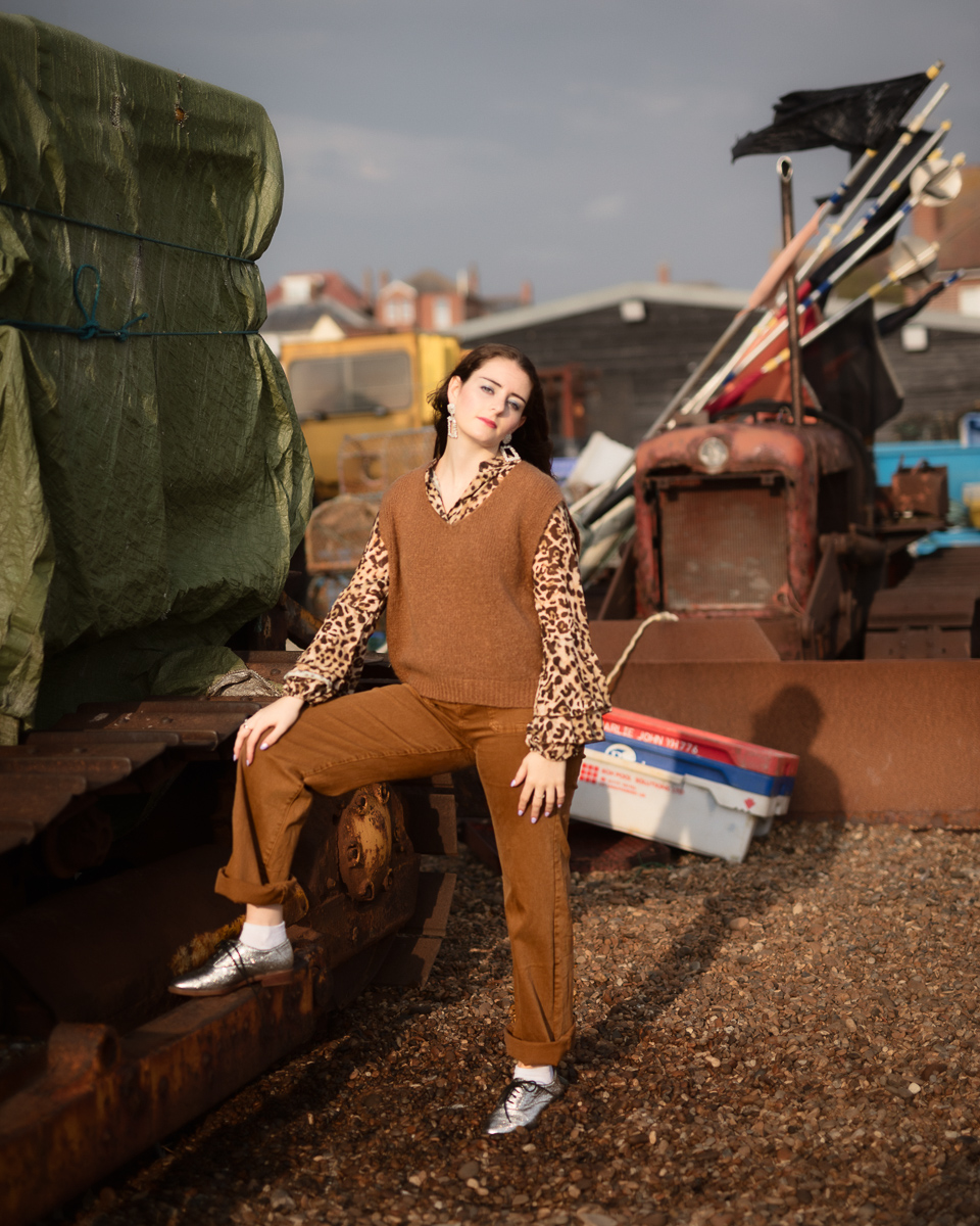 Person posing near industrial equipment outdoors.
