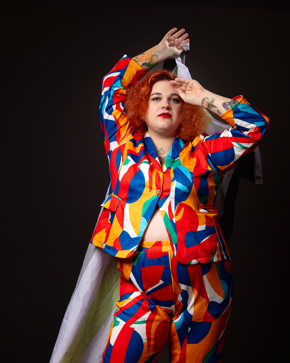 Person in colourful suit posing confidently