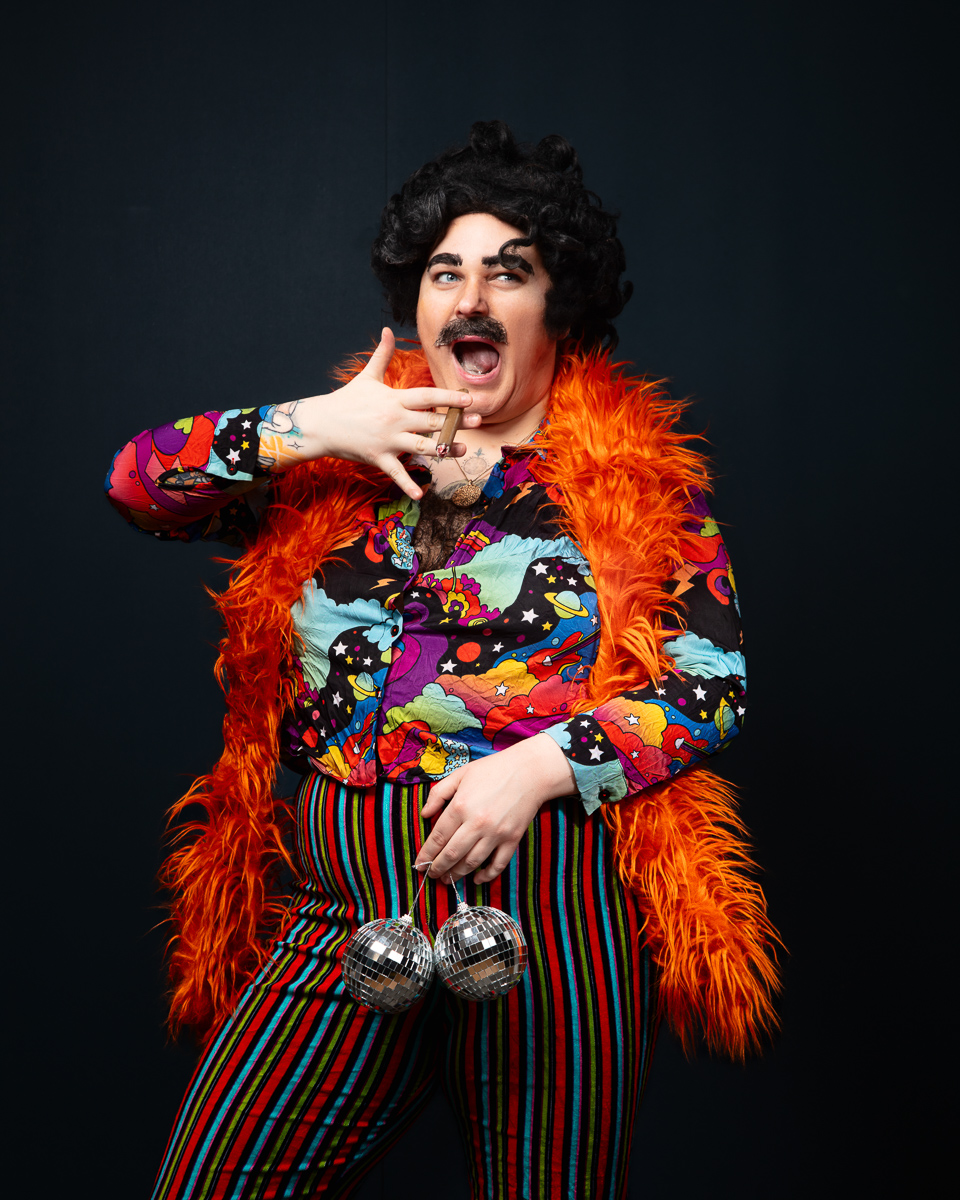 Person in colourful costume and feather boa