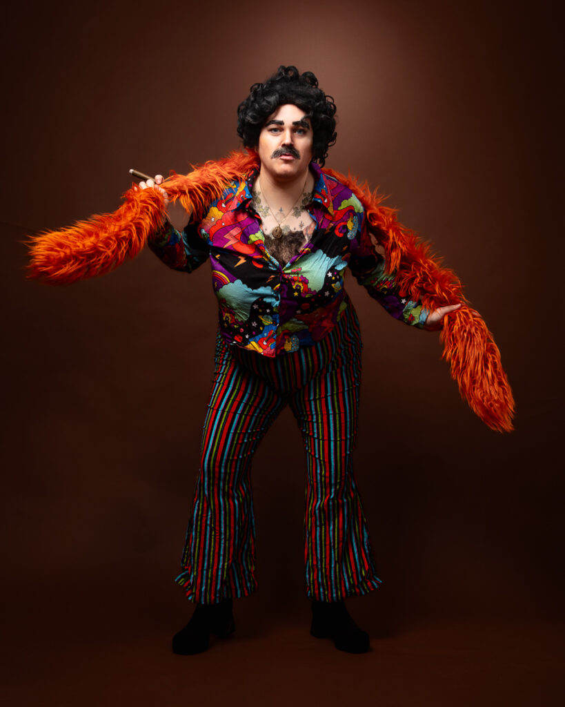 Person in colourful 70s outfit with feather boa.