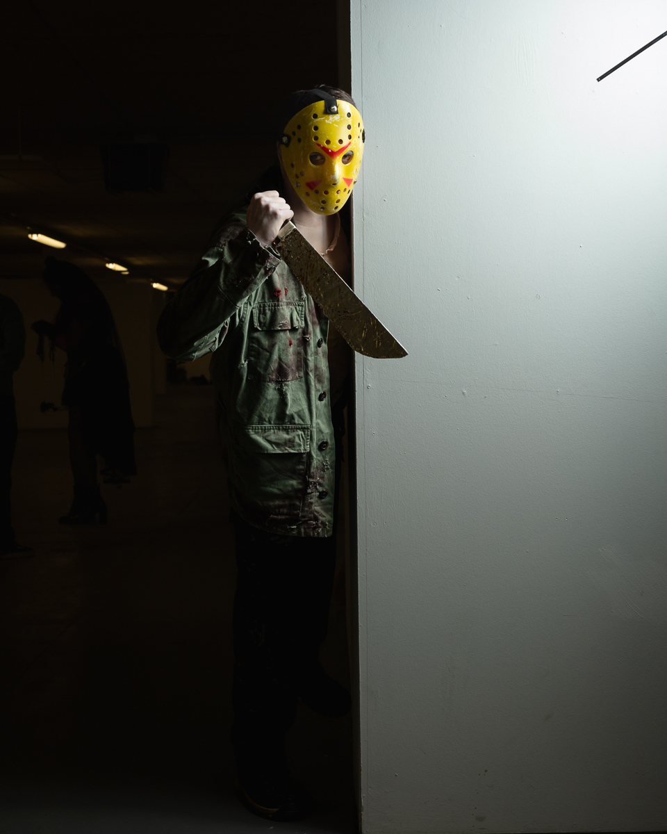 Figure wearing yellow Jason hockey mask holding large knife