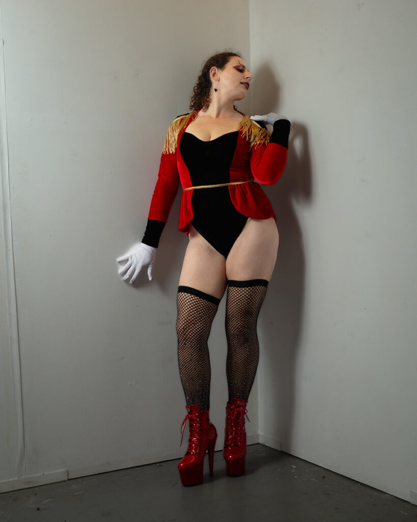 Woman in red and black performance costume with platform boots
