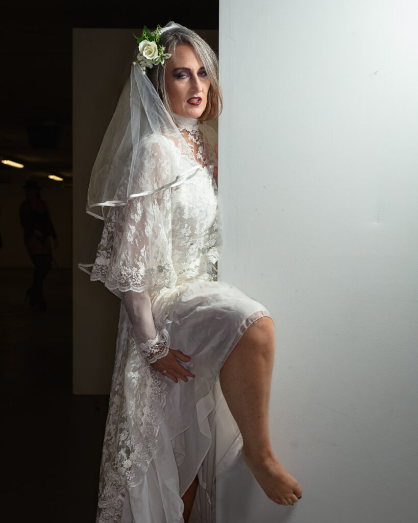 Bride in white lace dress with flower crown and veil