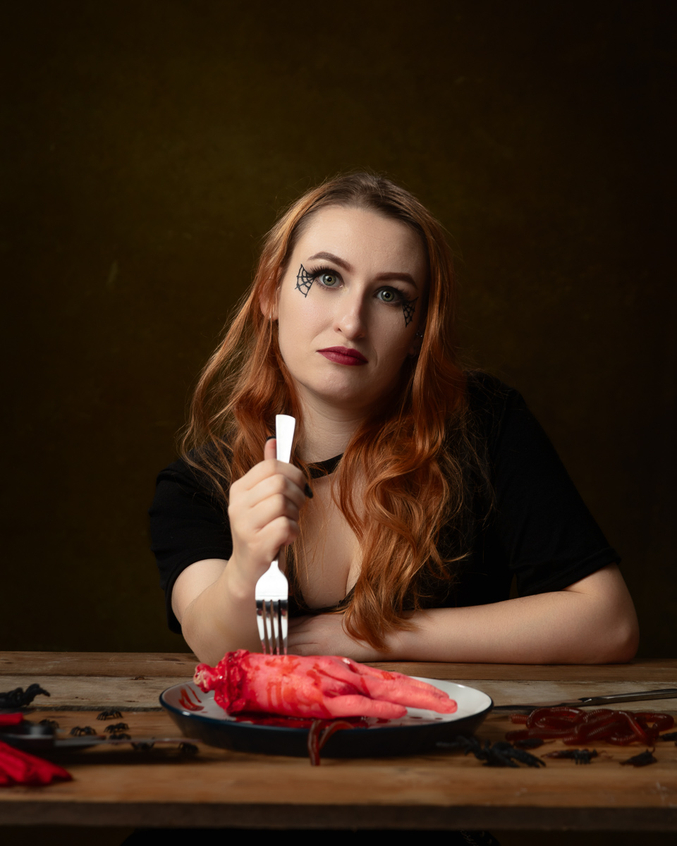Person with fork and spooky hand on plate