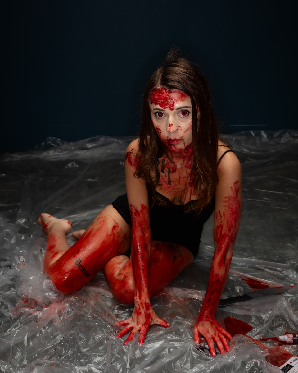 Woman covered in red paint artistic body art portrait