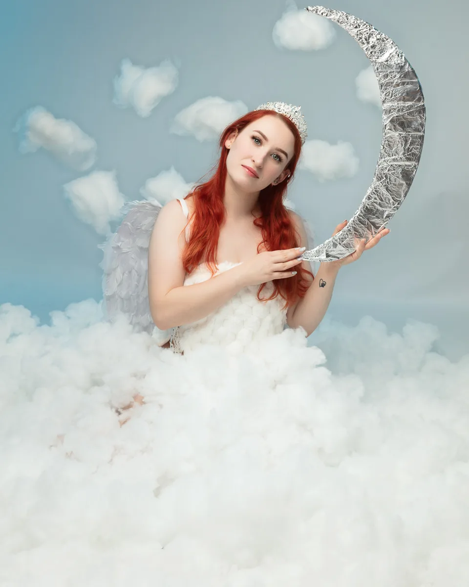Woman with red hair as celestial angel holding silver moon