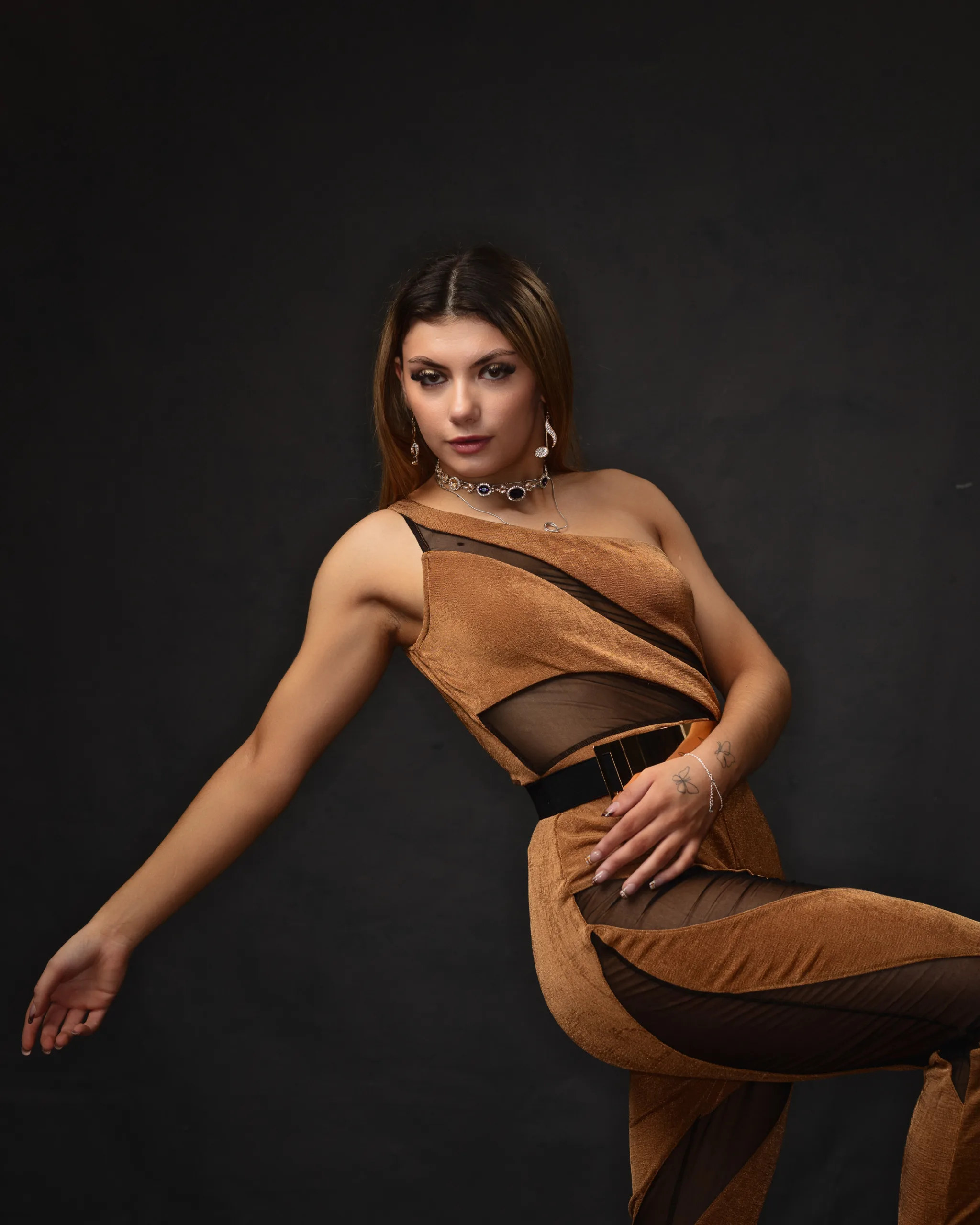 Woman posing in fashionable brown outfit