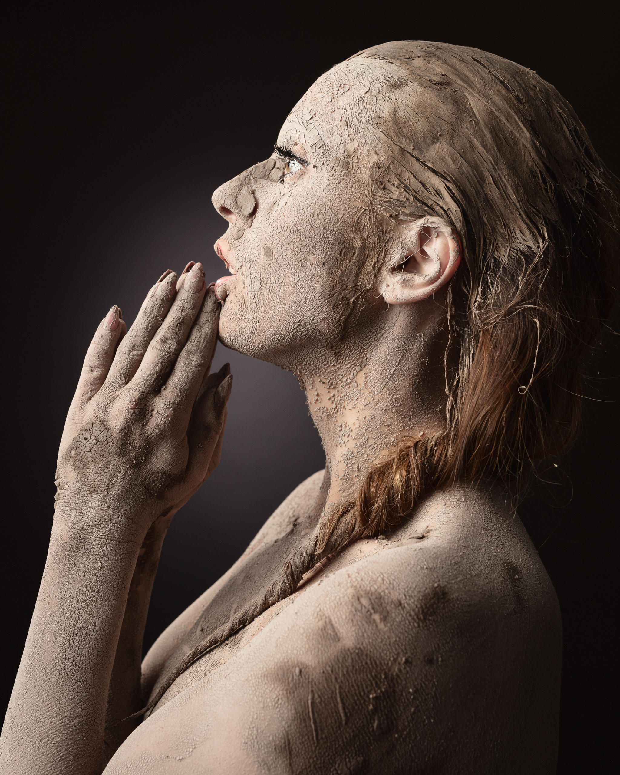 Woman covered in mud, artistic expression