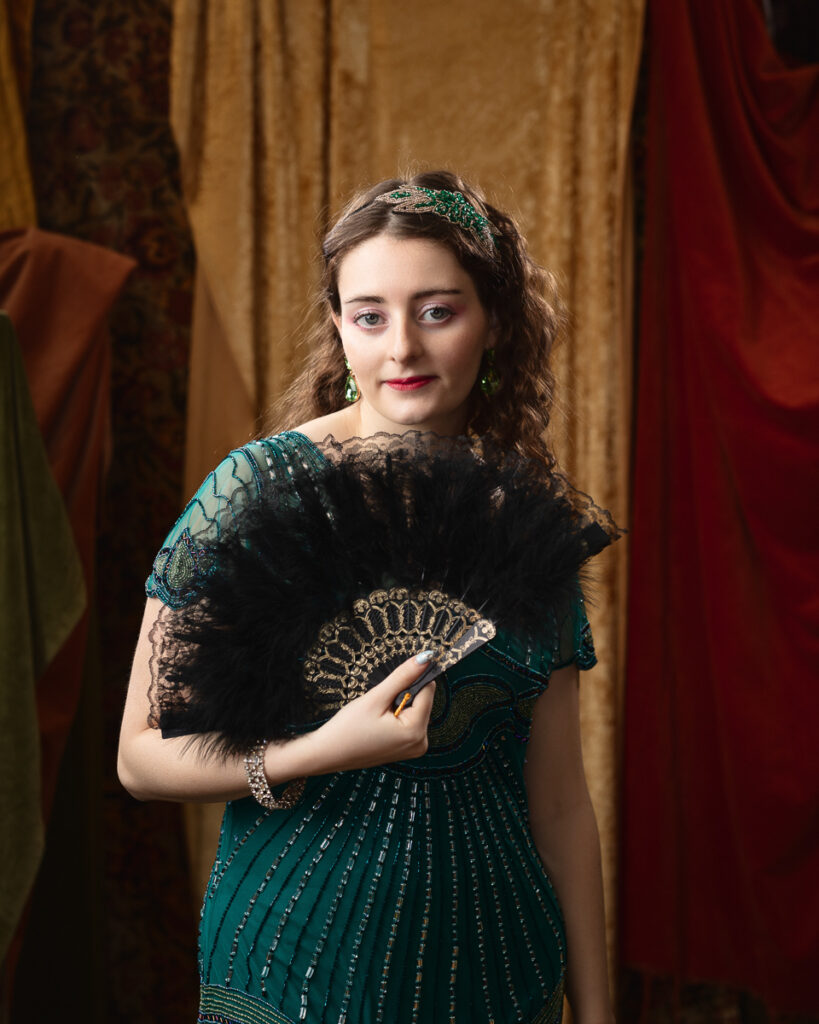 Woman in vintage attire with feather fan