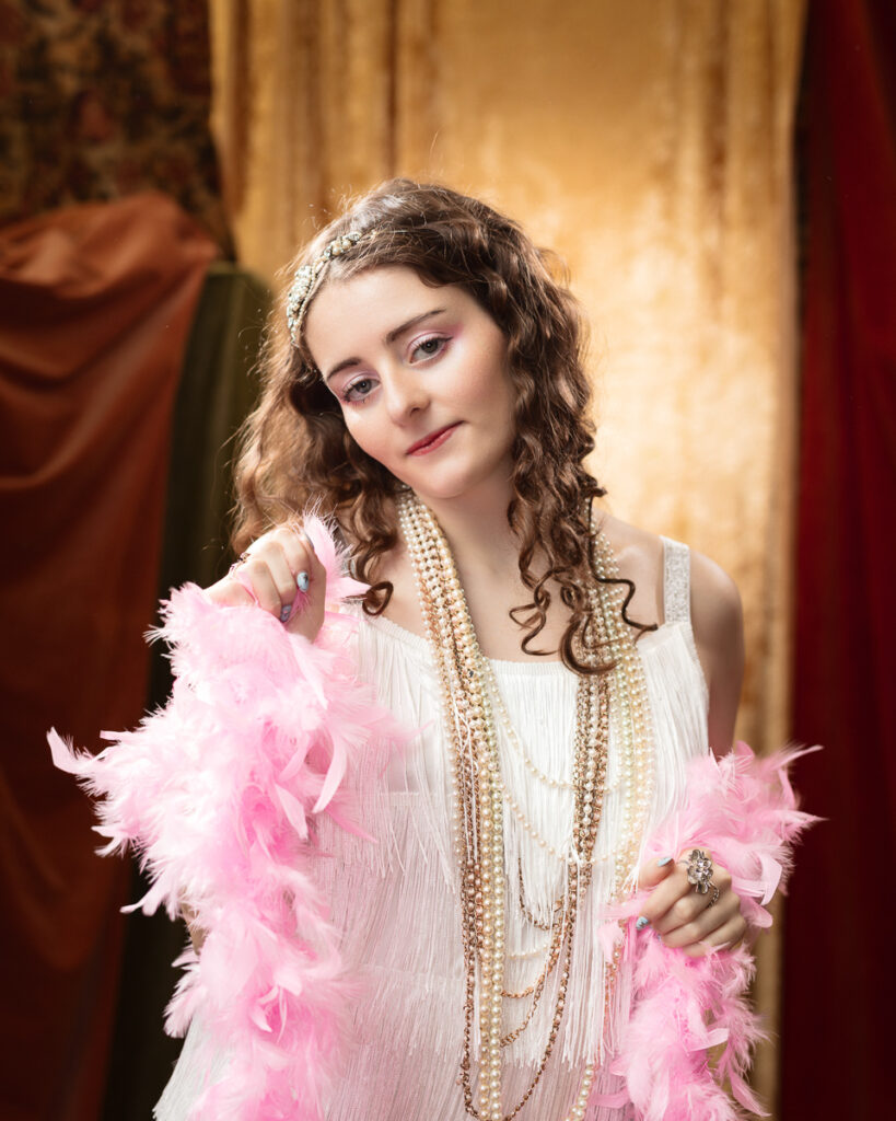 Woman in vintage dress with feather boa.